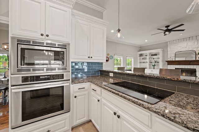 kitchen featuring crown molding, white cabinetry, appliances with stainless steel finishes, and ceiling fan