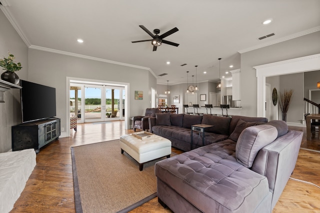 living room with ceiling fan, wood finished floors, visible vents, and recessed lighting