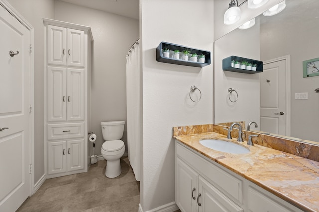 full bath with toilet, vanity, and baseboards