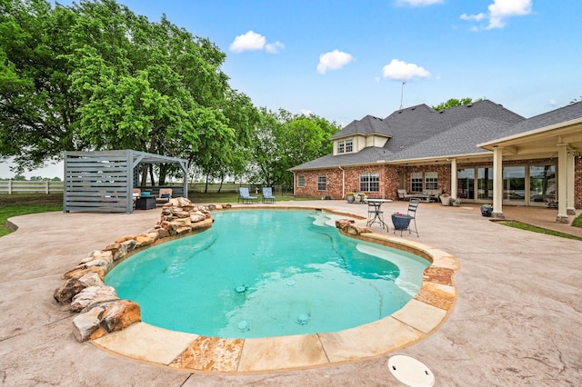 outdoor pool featuring a patio and fence