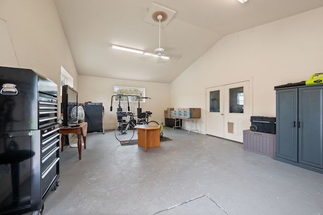 garage with a ceiling fan and french doors