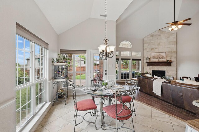 dining area with an inviting chandelier, arched walkways, and high vaulted ceiling