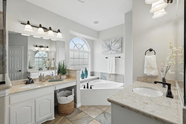 full bath with a garden tub, vanity, and a stall shower