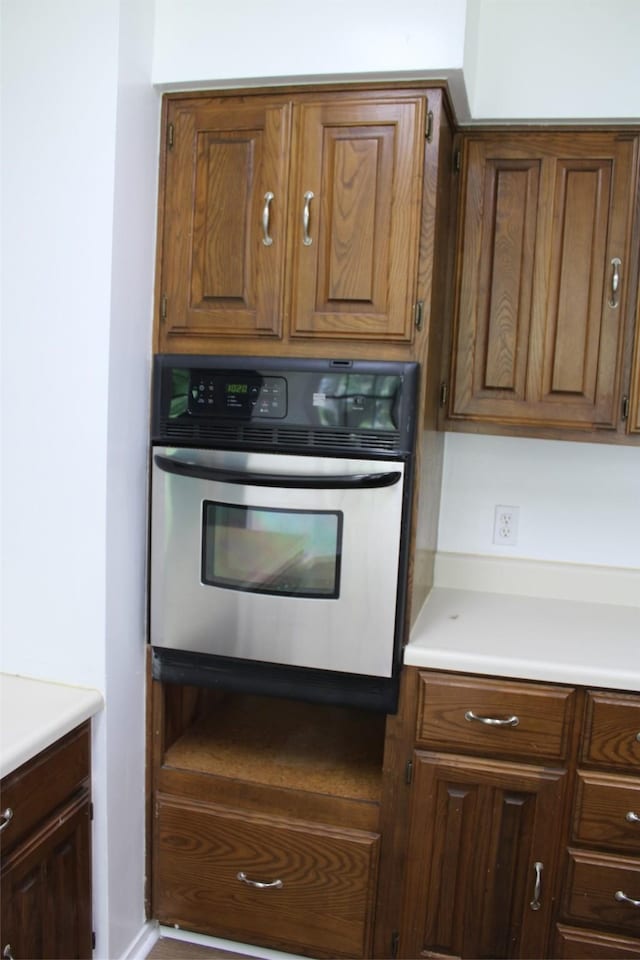 kitchen with oven and light countertops