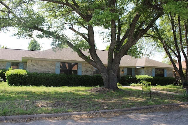 ranch-style house with brick siding and roof with shingles