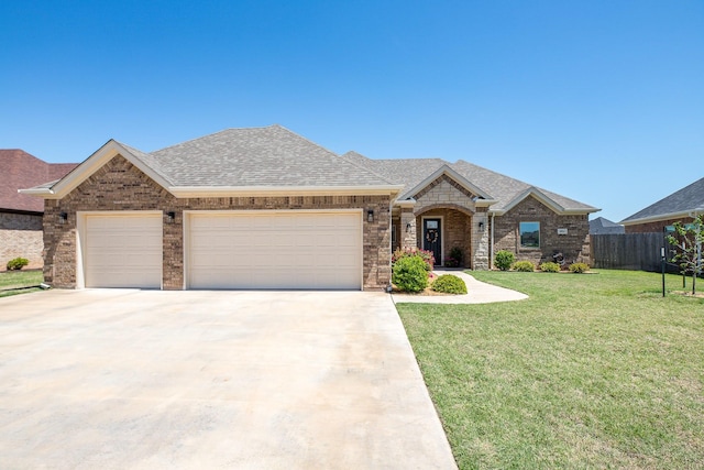 single story home with a front lawn, concrete driveway, fence, an attached garage, and a shingled roof