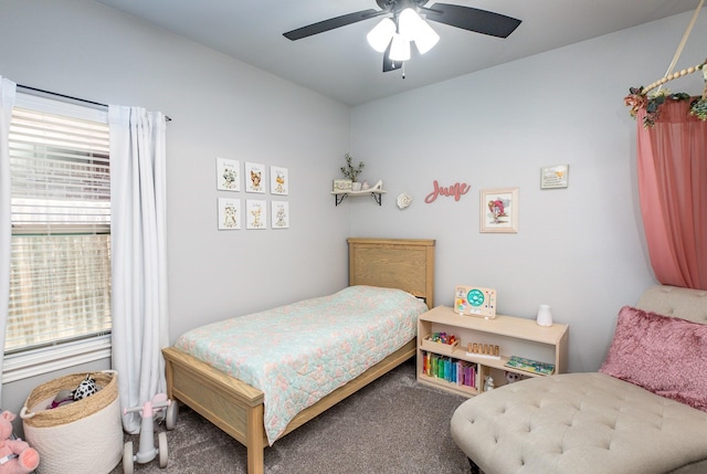 bedroom featuring a ceiling fan and carpet