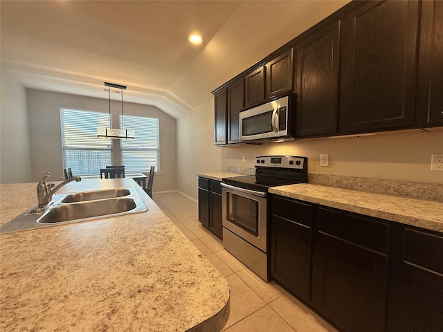1131 Grimes Dr, Forney, TX 75126 - kitchen featuring appliances with stainless steel finishes, lofted ceiling, light tile patterned floors, and light countertops