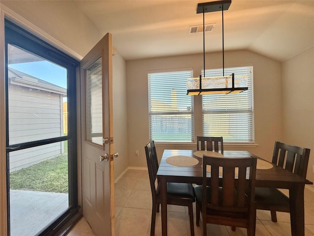 1131 Grimes Dr, Forney, TX 75126 - dining area with light tile patterned floors and vaulted ceiling