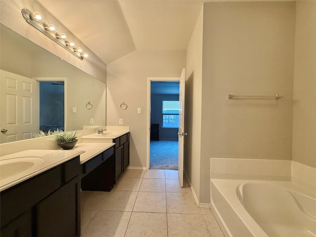 1131 Grimes Dr, Forney, TX 75126 - full bath with lofted ceiling, double vanity, tile patterned floors, and a garden tub
