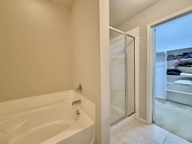1131 Grimes Dr, Forney, TX 75126 - bathroom featuring a garden tub, a shower stall, a spacious closet, and tile patterned floors