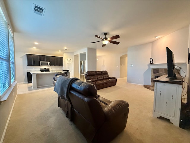 1131 Grimes Dr, Forney, TX 75126 - living room with light carpet, a ceiling fan, arched walkways, and recessed lighting