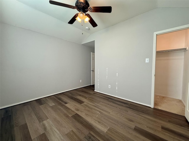 1131 Grimes Dr, Forney, TX 75126 - unfurnished bedroom with vaulted ceiling, a walk in closet, dark wood-type flooring, a ceiling fan, and a closet