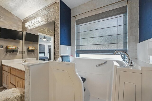 full bathroom featuring wallpapered walls, vanity, a tub, and ceiling fan