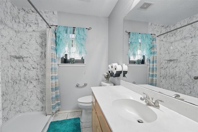 bathroom featuring vanity, toilet, tile patterned flooring, and a stall shower