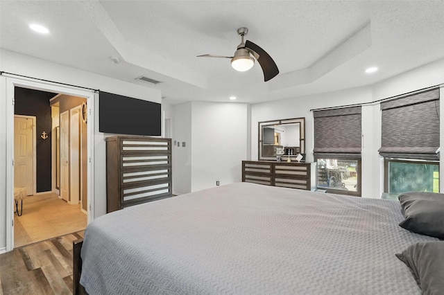 107 Princeton Cir, Forney, TX 75126 - bedroom featuring wood finished floors, a raised ceiling, recessed lighting, and ceiling fan