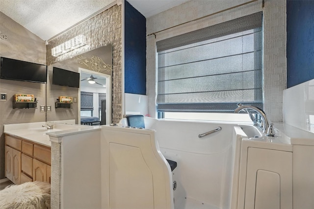 107 Princeton Cir, Forney, TX 75126 - bathroom featuring a garden tub, ceiling fan, vanity, and wallpapered walls