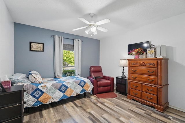 bedroom with wood finished floors and ceiling fan