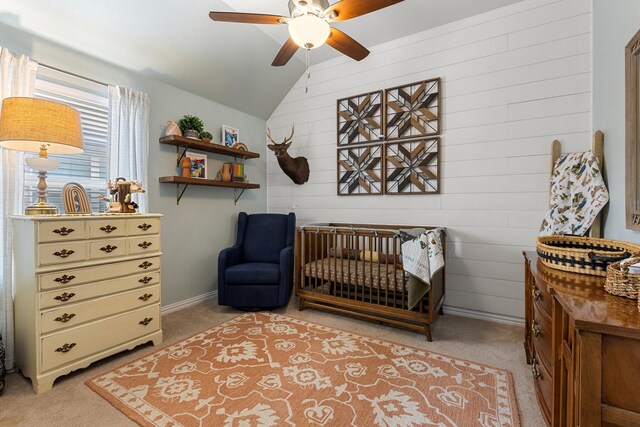 2452 Open Range Dr, Fort Worth, TX 76177 - bedroom featuring light colored carpet, lofted ceiling, a nursery area, wood walls, and a ceiling fan