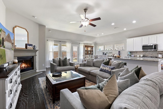 2452 Open Range Dr, Fort Worth, TX 76177 - living area featuring a ceiling fan, dark wood-style floors, a warm lit fireplace, and recessed lighting