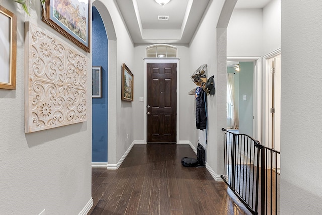 2452 Open Range Dr, Fort Worth, TX 76177 - foyer entrance with arched walkways, wood-type flooring, baseboards, a textured wall, and a tray ceiling