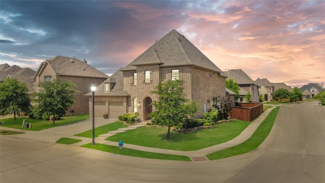 view of front of home with a residential view, a front lawn, brick siding, a garage, and driveway