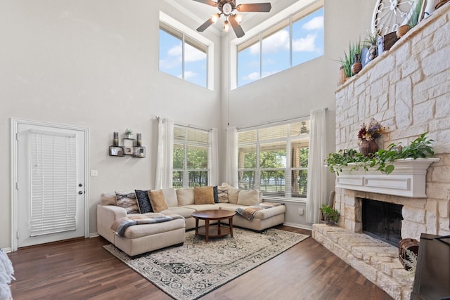 3001 Shoreline Dr, Burleson, TX 76028 - living room with healthy amount of natural light, ceiling fan, wood finished floors, a towering ceiling, and a stone fireplace