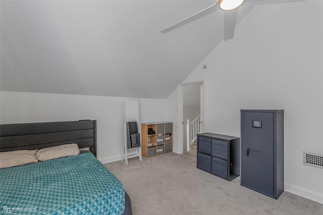 bedroom with light carpet, lofted ceiling, and baseboards