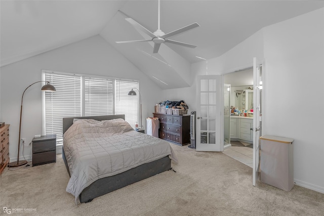 carpeted bedroom featuring french doors, vaulted ceiling, ensuite bath, a ceiling fan, and baseboards