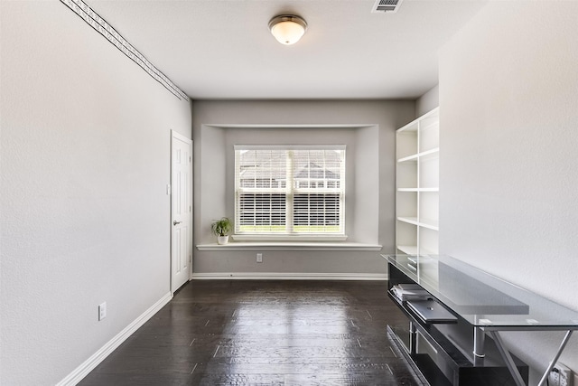 unfurnished dining area featuring baseboards, wood finished floors, and visible vents