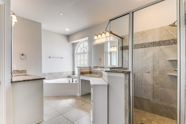 bathroom with a bath, tile patterned floors, vanity, and a stall shower