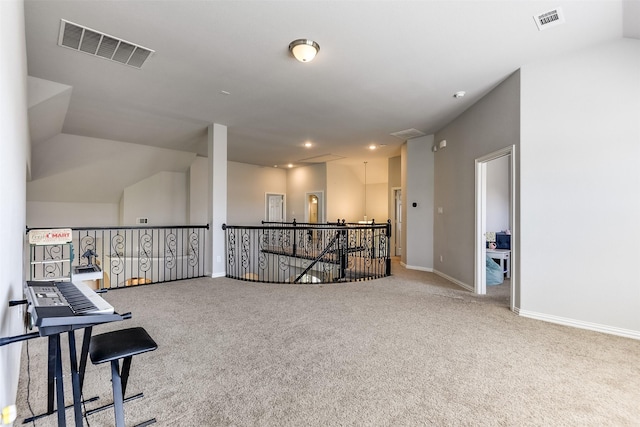 interior space featuring carpet floors, visible vents, baseboards, and an upstairs landing