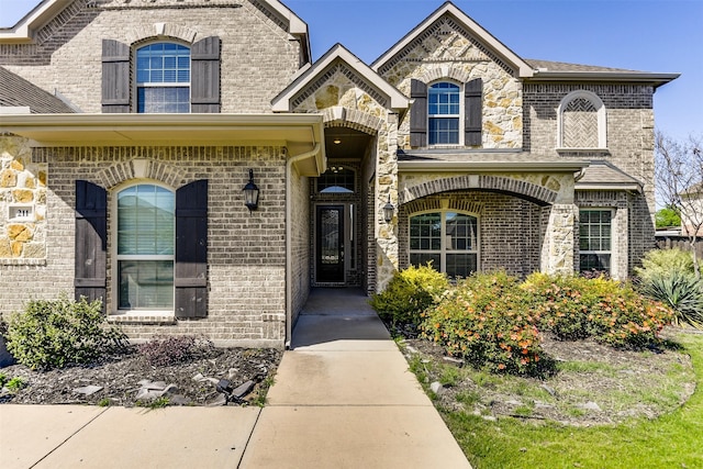 entrance to property featuring brick siding