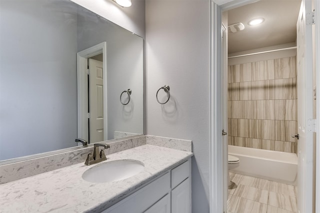 bathroom with toilet, vanity, and shower / bathing tub combination