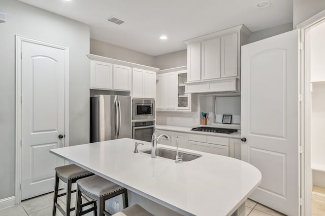 kitchen featuring recessed lighting, white cabinets, visible vents, a sink, and appliances with stainless steel finishes