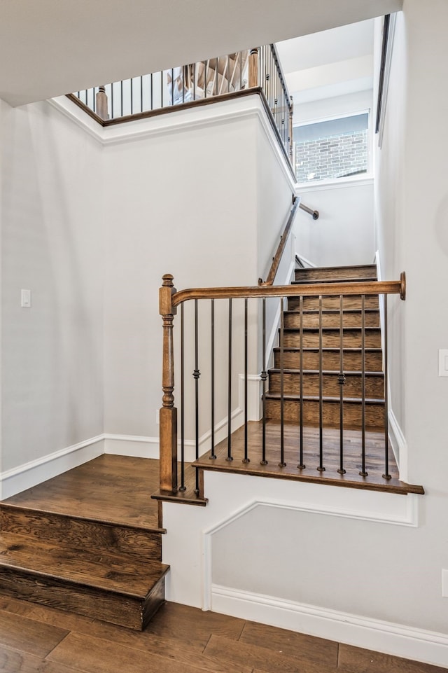 stairs with baseboards and wood finished floors