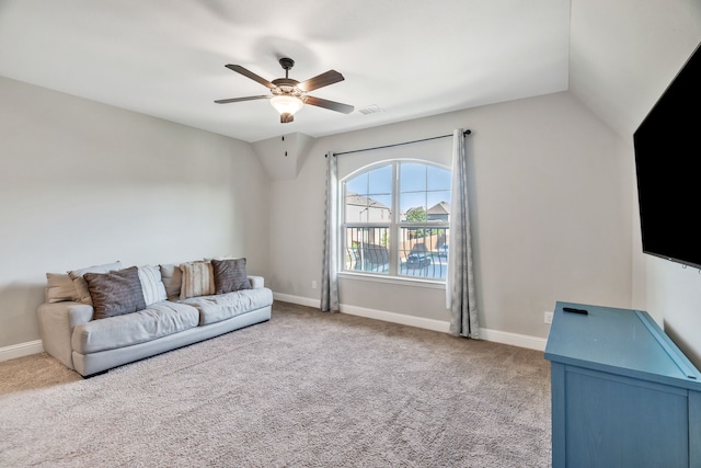 carpeted living area with ceiling fan, lofted ceiling, and baseboards