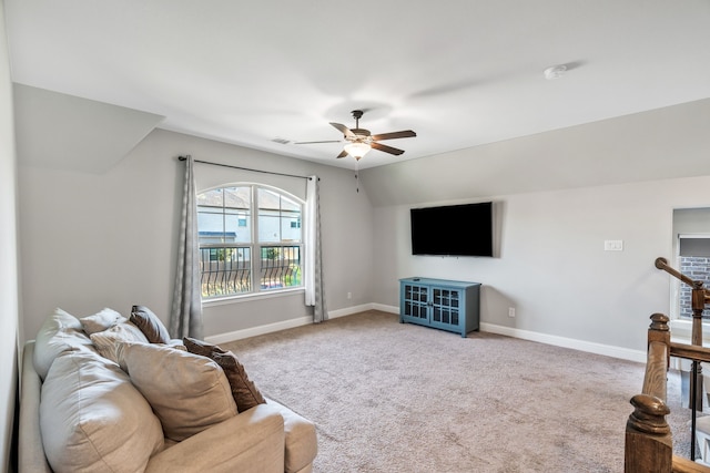 carpeted living area featuring ceiling fan, baseboards, vaulted ceiling, and visible vents