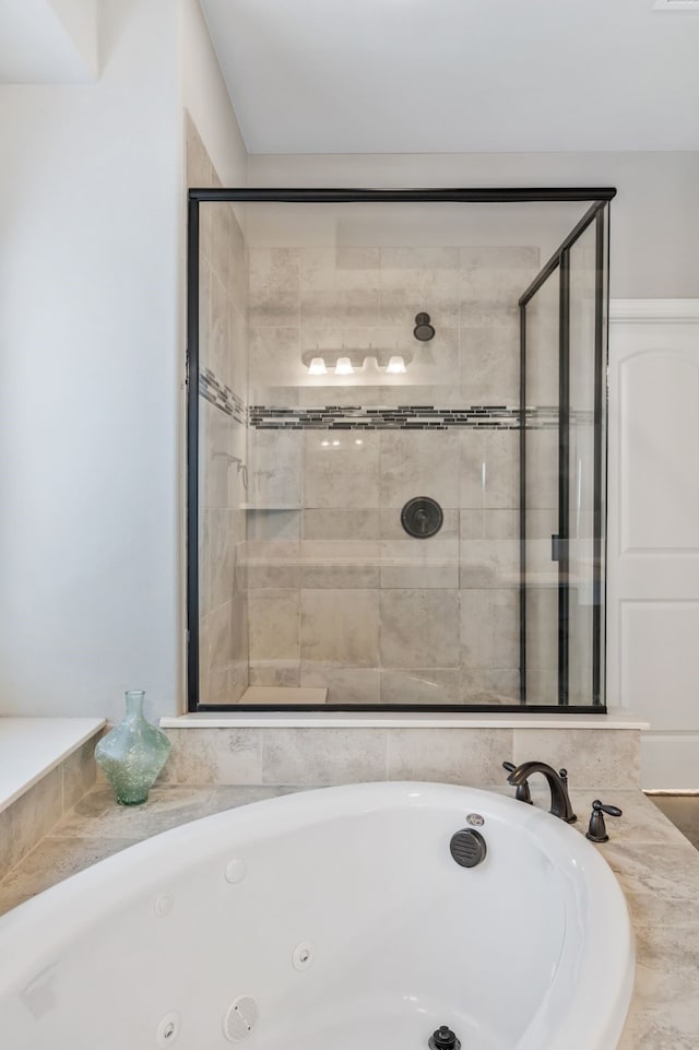 full bathroom featuring a jetted tub and a stall shower
