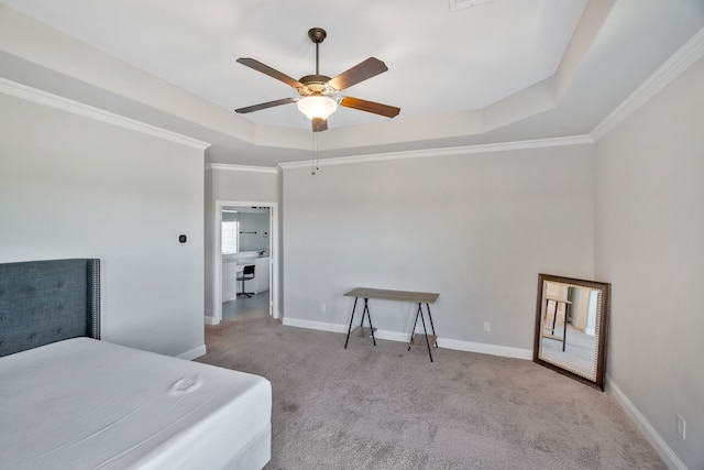 bedroom with a tray ceiling, carpet, crown molding, and baseboards