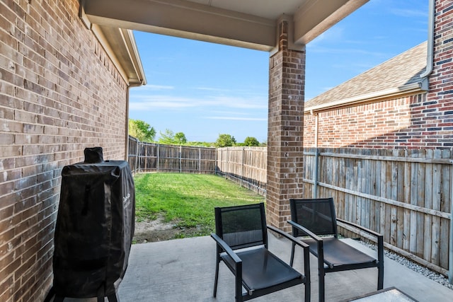view of patio with a fenced backyard and a grill