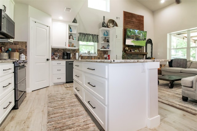 kitchen with open shelves, a center island, high vaulted ceiling, and black appliances