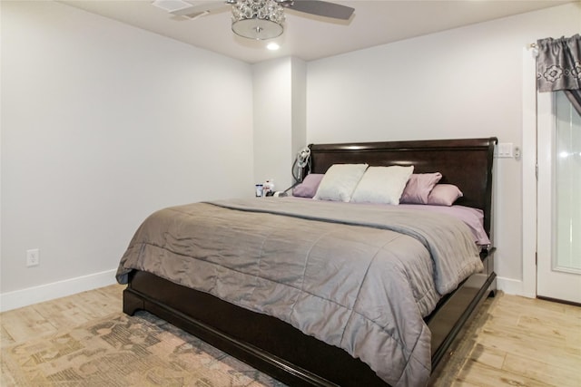 bedroom featuring baseboards, a ceiling fan, and wood finished floors