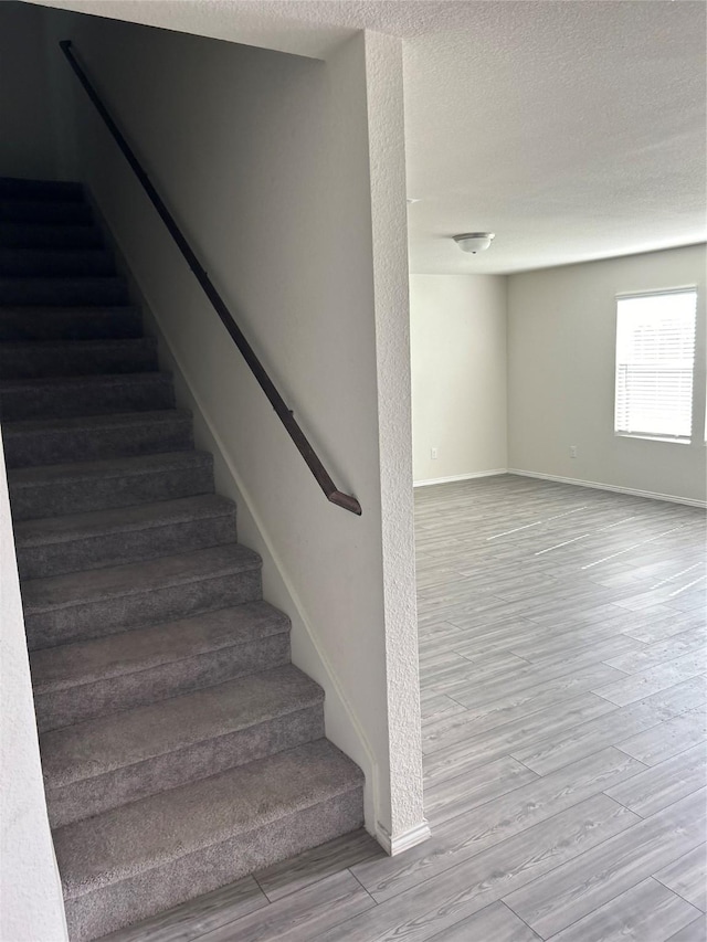 16033 Rein Ave, Haslet, TX 76052 - stairs with wood finished floors, a textured ceiling, and baseboards