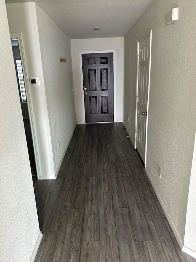 16033 Rein Ave, Haslet, TX 76052 - corridor featuring a textured wall, baseboards, and dark wood-style floors