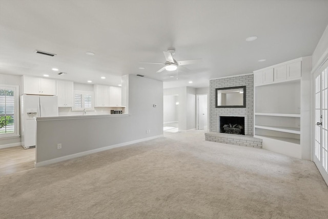 3141 La Kenta Cir, Farmers Branch, TX 75234 - unfurnished living room featuring ceiling fan, light colored carpet, baseboards, a fireplace, and recessed lighting