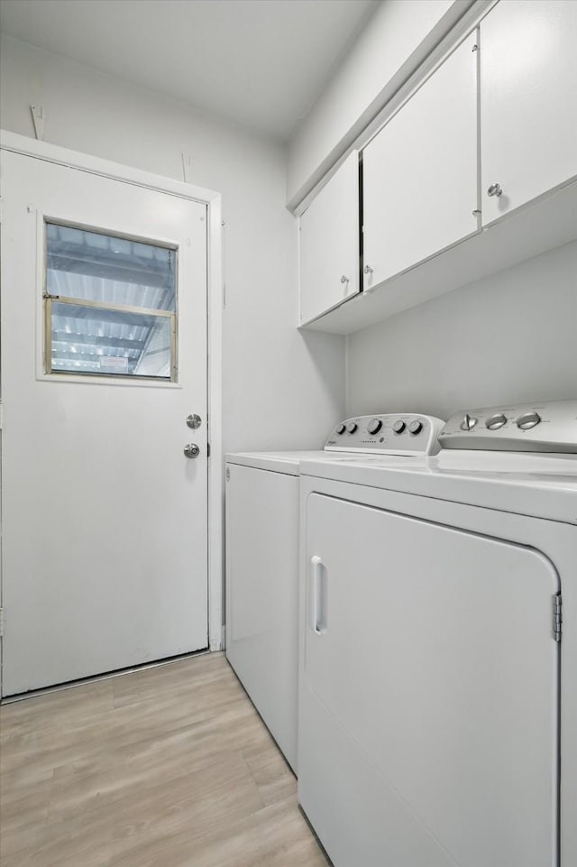 3141 La Kenta Cir, Farmers Branch, TX 75234 - washroom featuring cabinet space, independent washer and dryer, and light wood-style floors