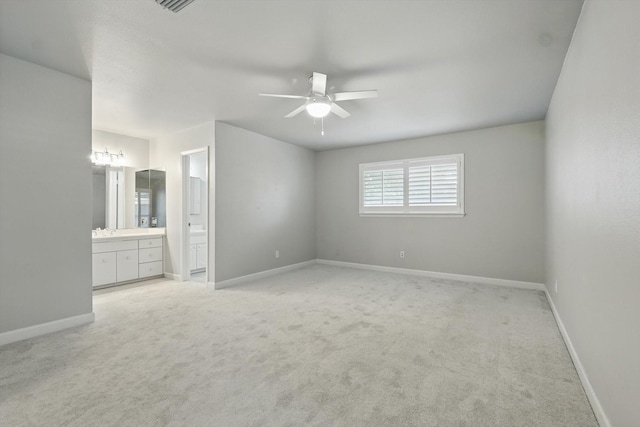 3141 La Kenta Cir, Farmers Branch, TX 75234 - unfurnished bedroom featuring light carpet, ensuite bathroom, baseboards, and a ceiling fan