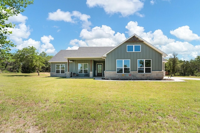 1295 County Road 2030, Glen Rose, TX 76043 - view of front of house with board and batten siding, a front yard, roof with shingles, and stone siding