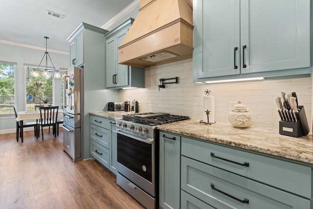 1295 County Road 2030, Glen Rose, TX 76043 - kitchen with appliances with stainless steel finishes, custom exhaust hood, crown molding, light stone countertops, and dark wood-type flooring